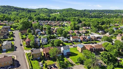 an aerial view of multiple houses with yard