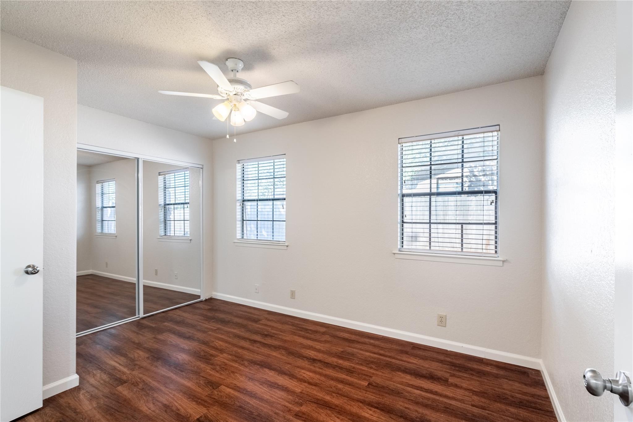3800 Foust Trail, Unit B Georgetown, TX 78628 - Photo 10 of 16 Rich wood-look flooring and generous window views define this comfortable bedroom space.