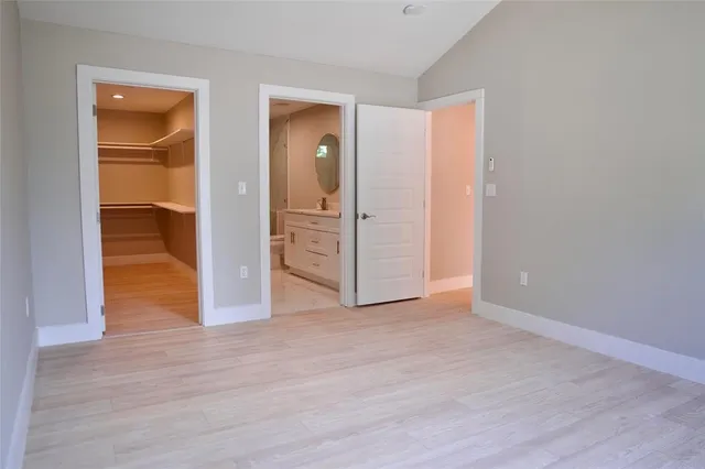 an empty room with wooden floor and closet