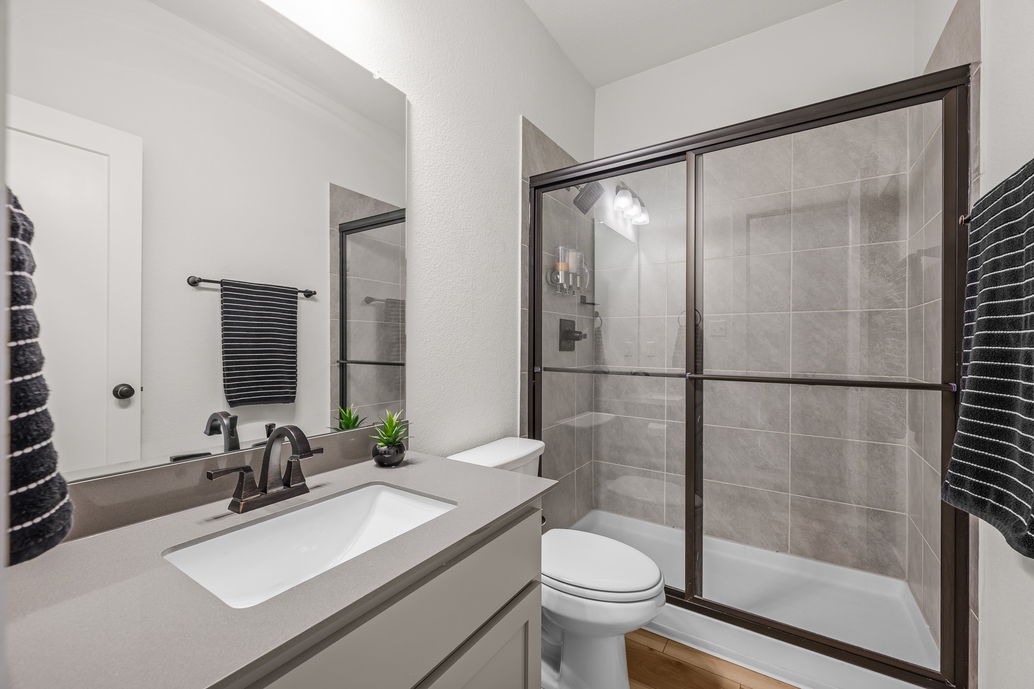 68 Rancho Trail Georgetown, TX 78628 - Photo 20 of 39 A well-appointed bathroom features a modern vanity with sleek countertops and a spacious walk-in shower.