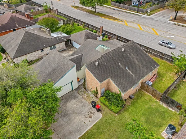 an aerial view of a house with a yard