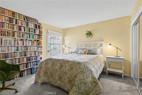 a bedroom with a bed and a book shelf