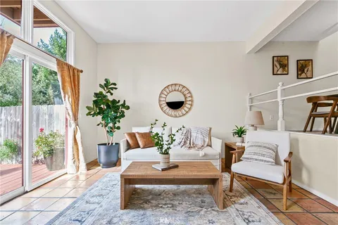 a living room with furniture a table and a potted plant