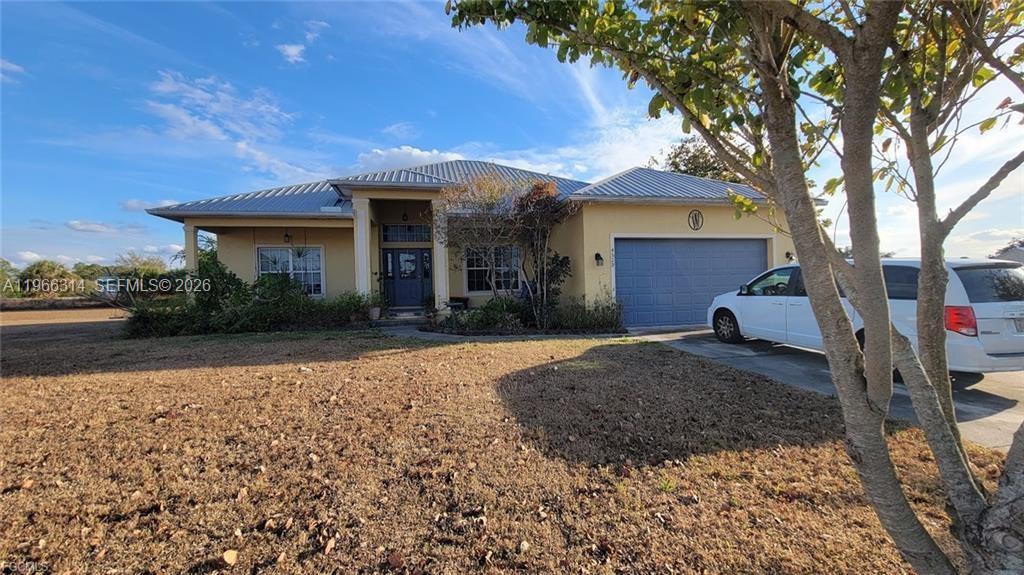 4529 Springview Circle LaBelle, FL 33935 - Photo 1 of 11 a front view of a house with a yard