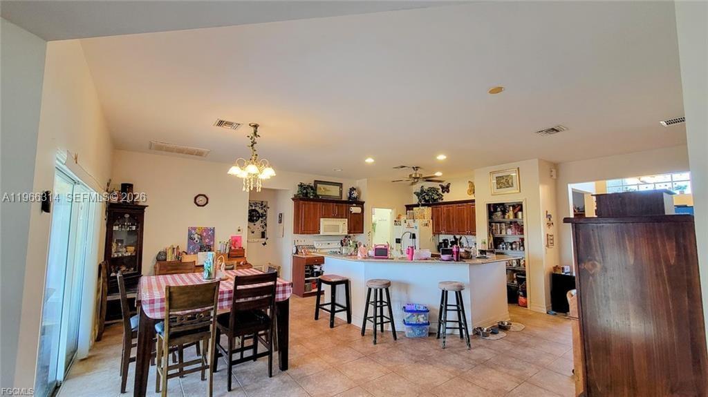 4529 Springview Circle LaBelle, FL 33935 - Photo 3 of 11 a view of a dining area with furniture and chandelier