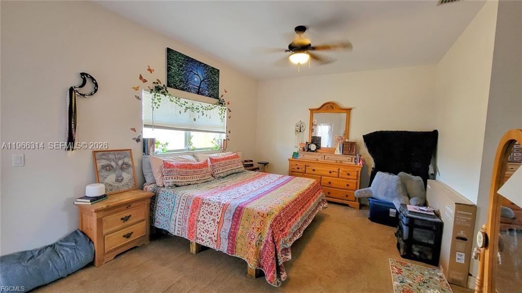 4529 Springview Circle LaBelle, FL 33935 - Photo 5 of 11 a bedroom with a bed and a chair