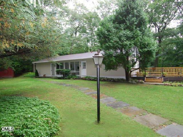 17 Hackberry Hill Road Weston, CT 06883 - Photo 1 of 1 a view of a house with a yard and tree s