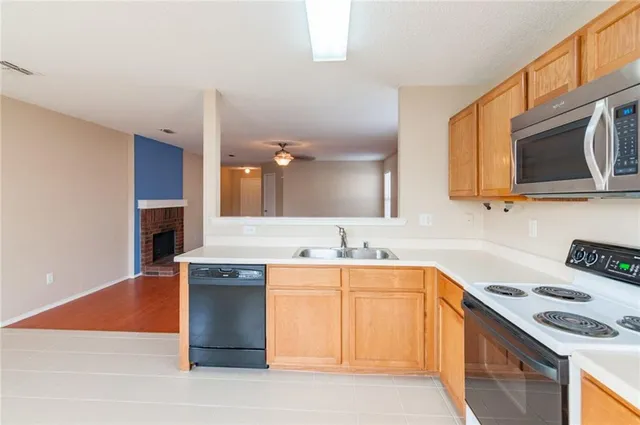 a kitchen with stainless steel appliances granite countertop a sink stove and microwave