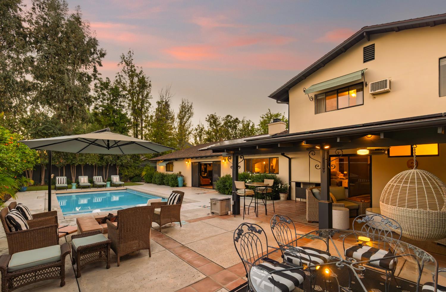 1213 San Ramon Way Ojai, CA 93023 - Photo 3 of 35 a view of a patio with couches table and chairs under an umbrella with a barbeque