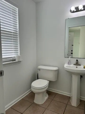 a white toilet sitting next to a bathroom sink