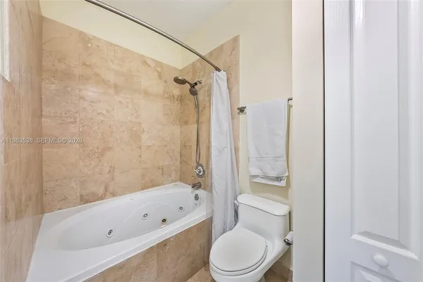 a bathroom with a toilet bathtub and shower