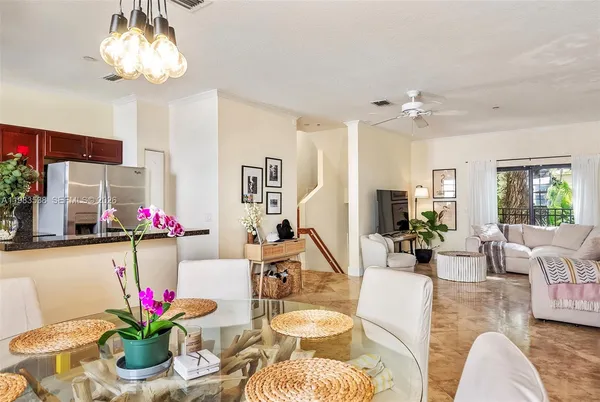 a living room with furniture and flowers