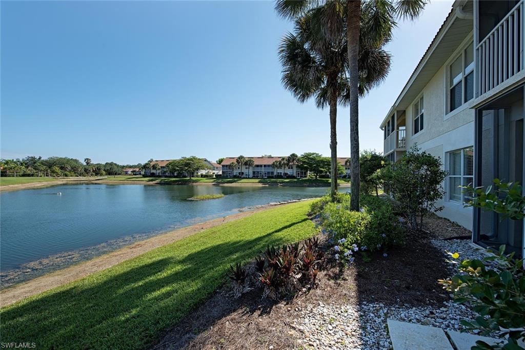 4960 Deerfield Way, Unit E103 Naples, FL 34110 - Photo 14 of 14 a view of a garden with a lake
