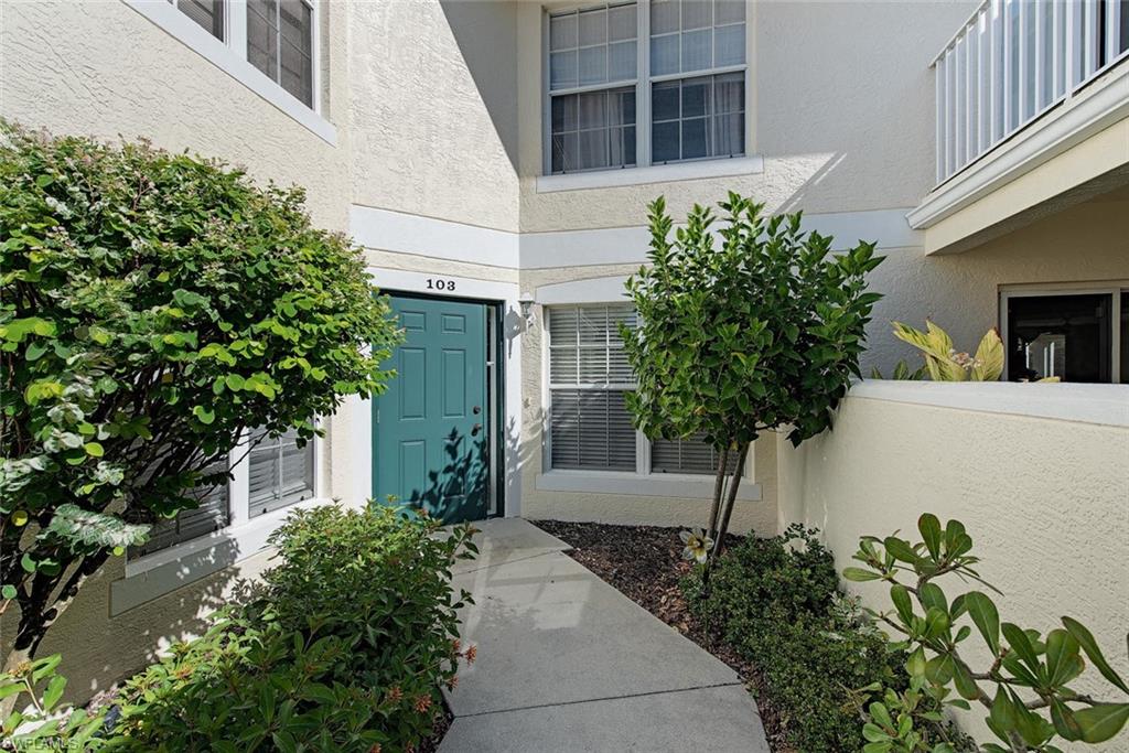 4960 Deerfield Way, Unit E103 Naples, FL 34110 - Photo 3 of 14 a view of a house with a tree