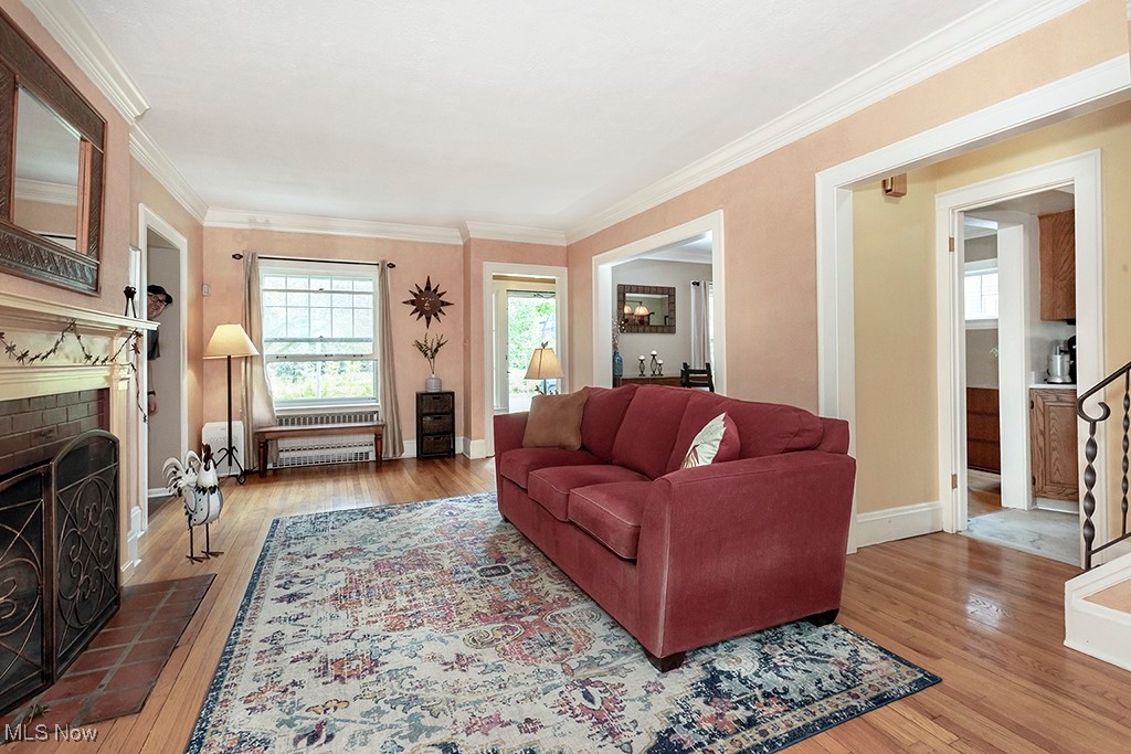3256 Aberdeen Road Cleveland, OH 44120 - Photo 15 of 46 Living room featuring a fireplace, ornamental molding, and wood-type flooring