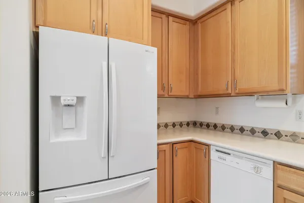 a kitchen with stainless steel appliances granite countertop white cabinets and a stove top oven