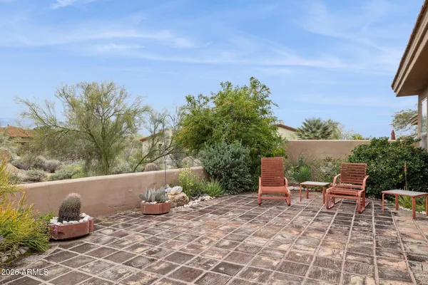 a view of a patio with table and chairs and potted plants