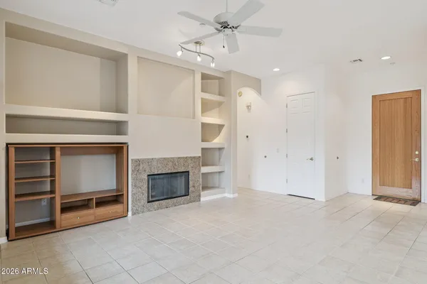 a view of entryway with a flower garden in front of main door