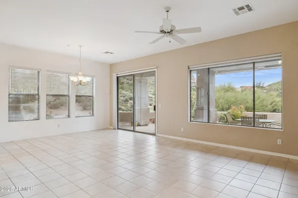 a view of an empty room with a fireplace and a window