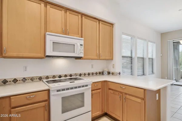 a kitchen with stainless steel appliances granite countertop a sink and a refrigerator