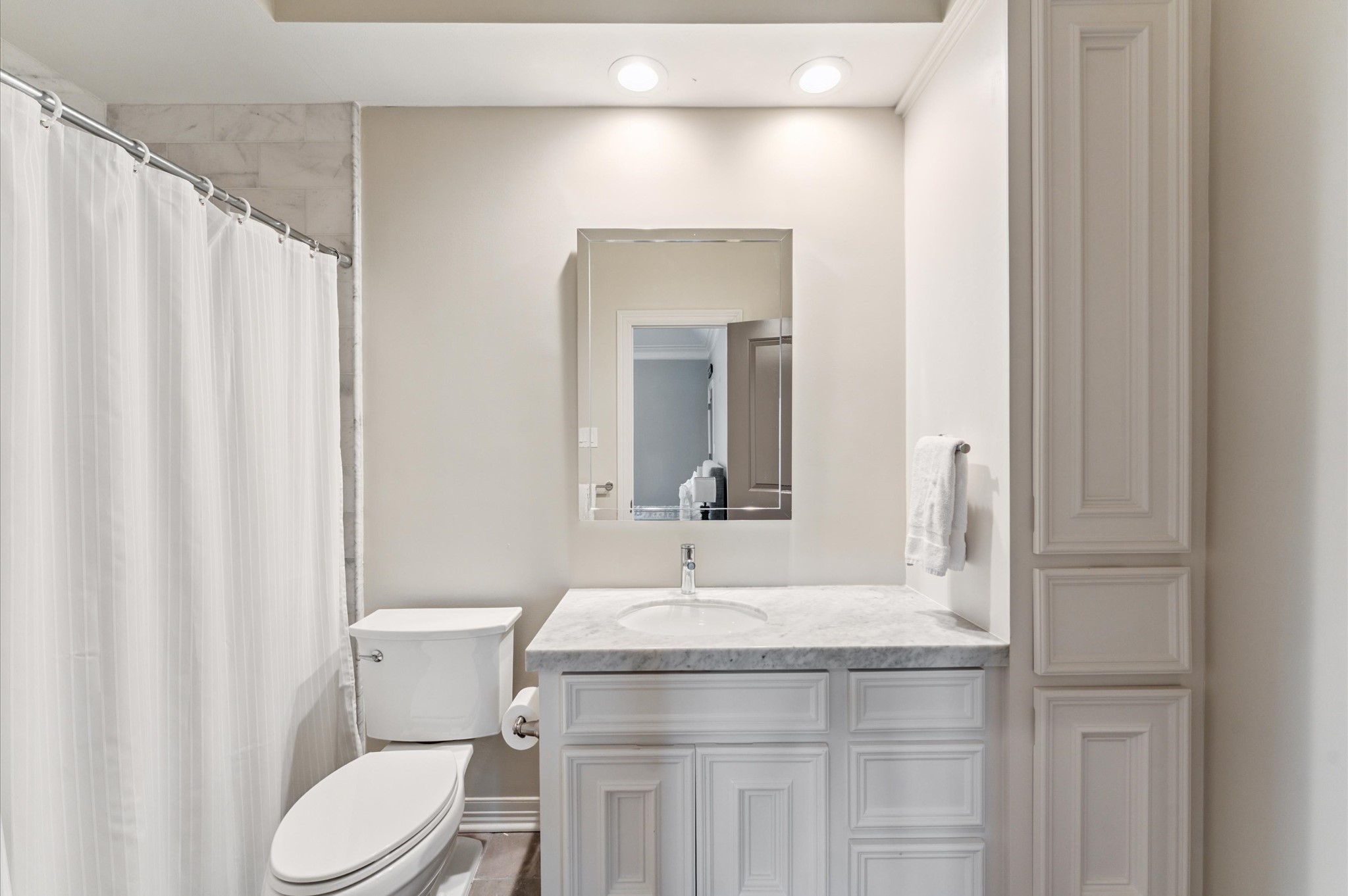 7 Marilane Street Houston, TX 77007 - Photo 31 of 45 a bathroom with a granite countertop sink vanity mirror and toilet