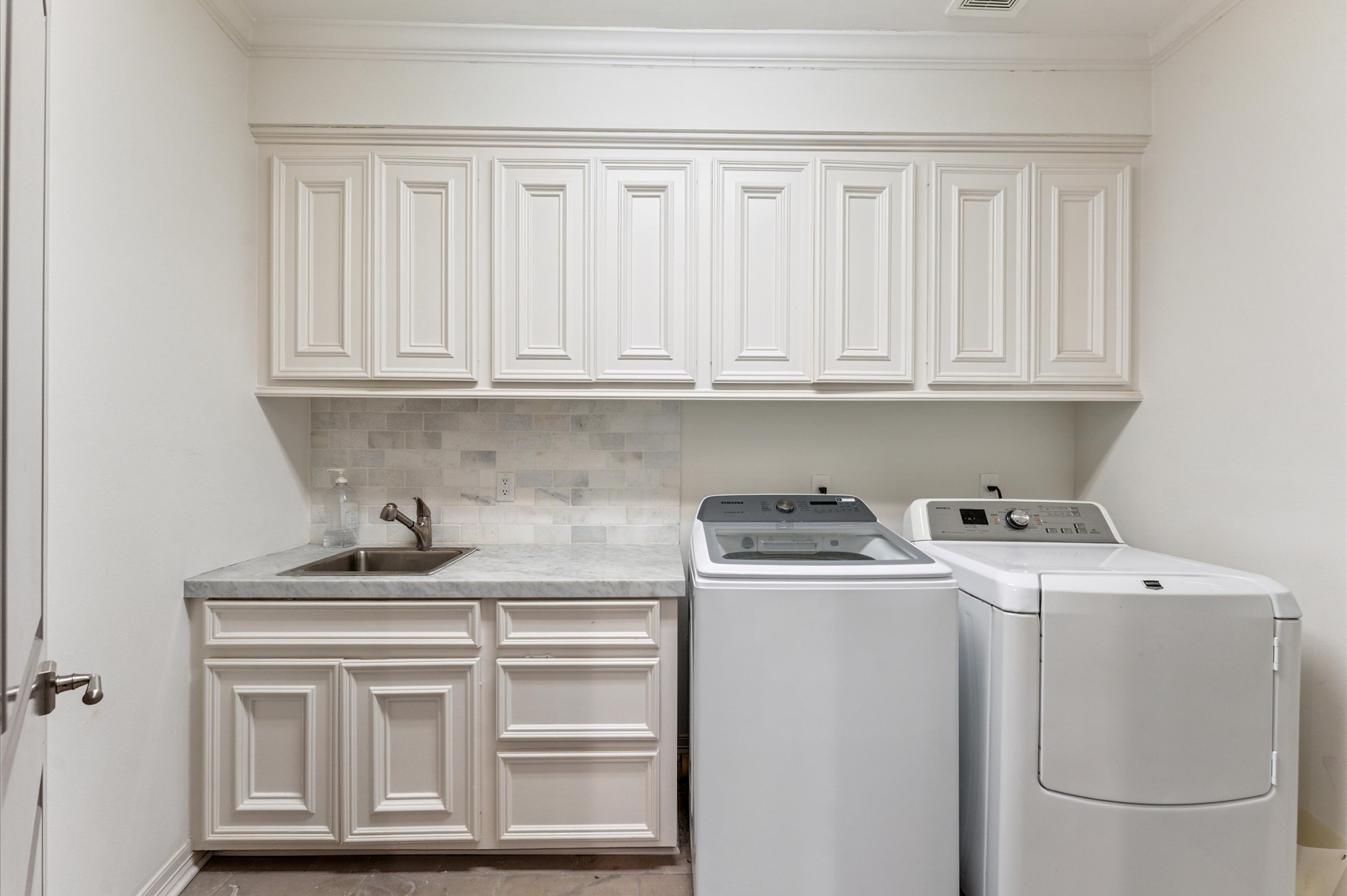 7 Marilane Street Houston, TX 77007 - Photo 36 of 45 a view of cabinets with washer and dryer