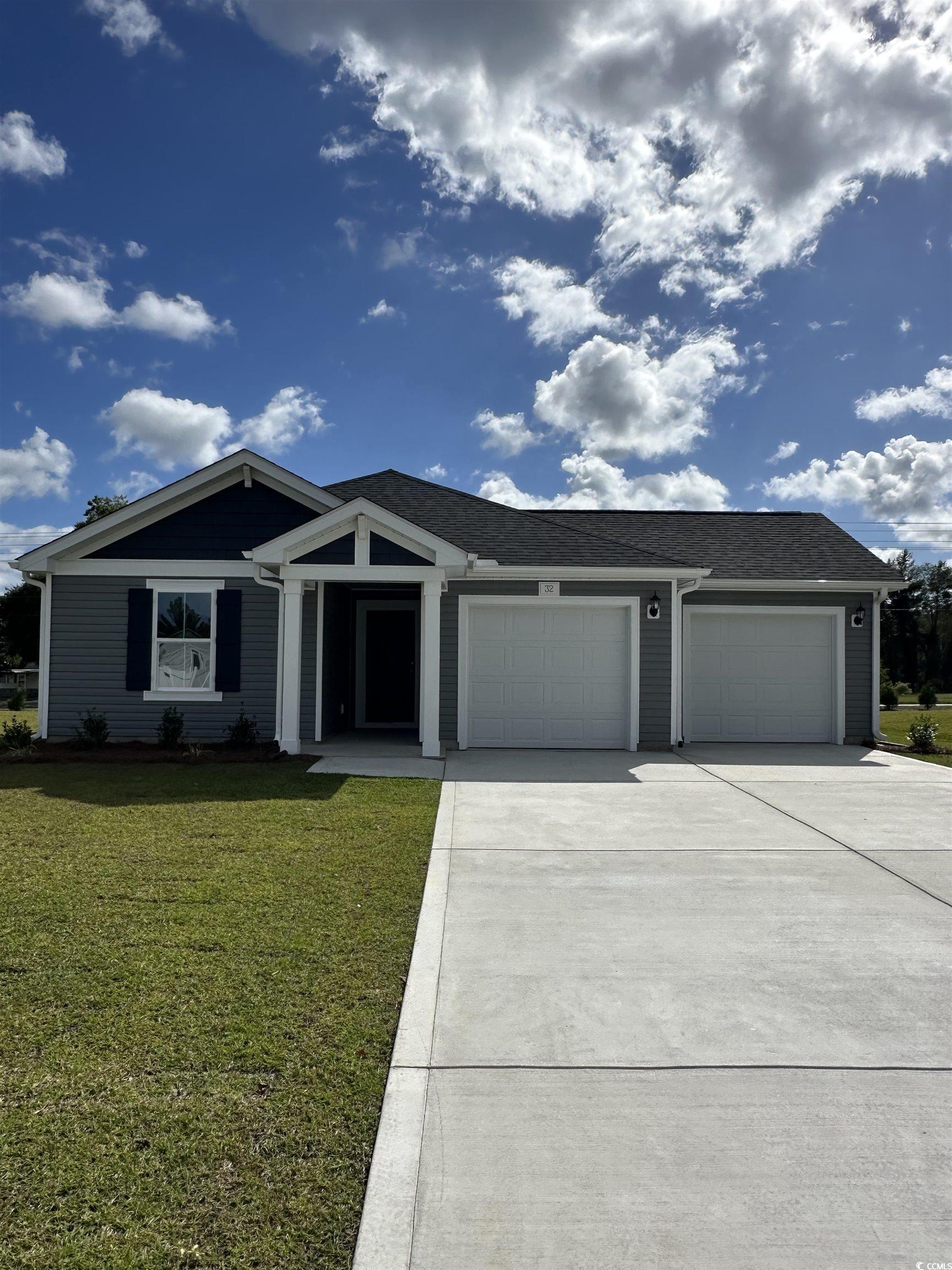Ranch-style house with a front yard, driveway, an attached garage, and a shingled roof