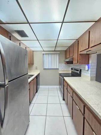 a kitchen with stainless steel appliances granite countertop a refrigerator and a sink