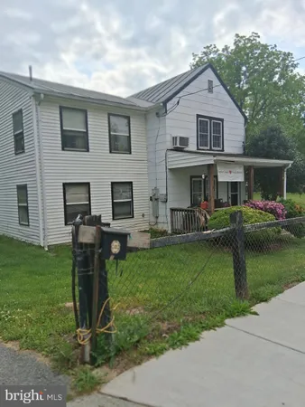 a front view of house with yard and outdoor seating