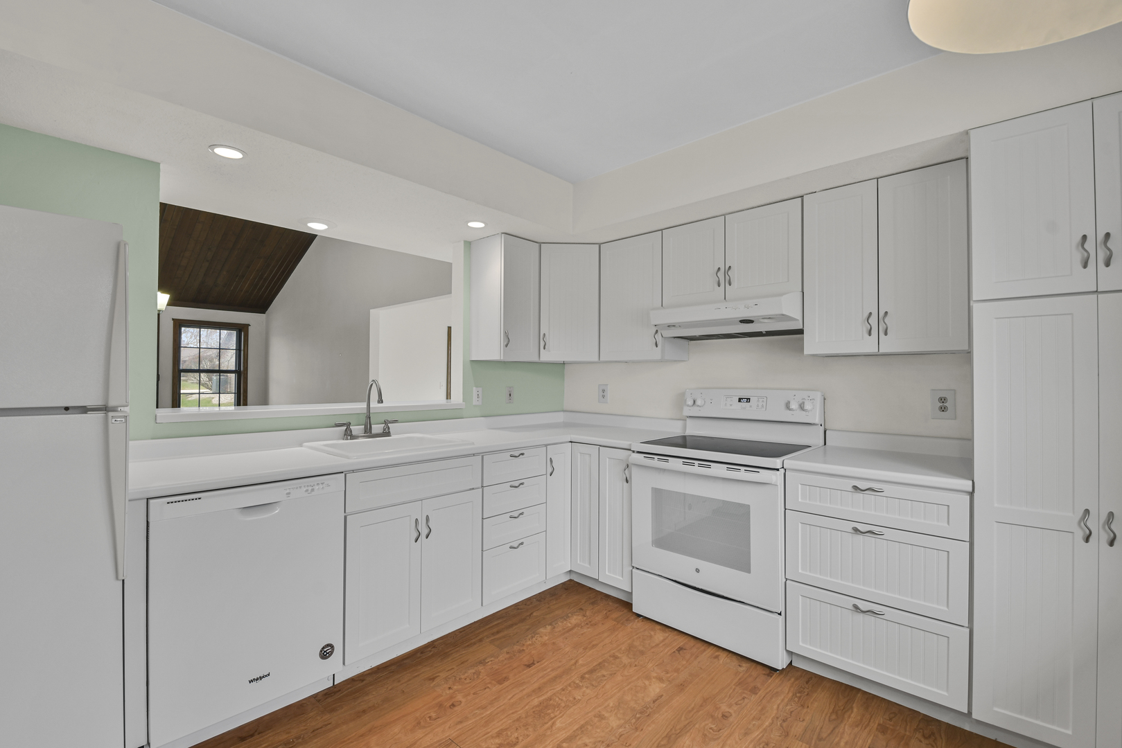 212 Spring Circle, Unit 212 Urbana, IL 61802 - Photo 5 of 22 a kitchen with white cabinets stainless steel appliances and sink