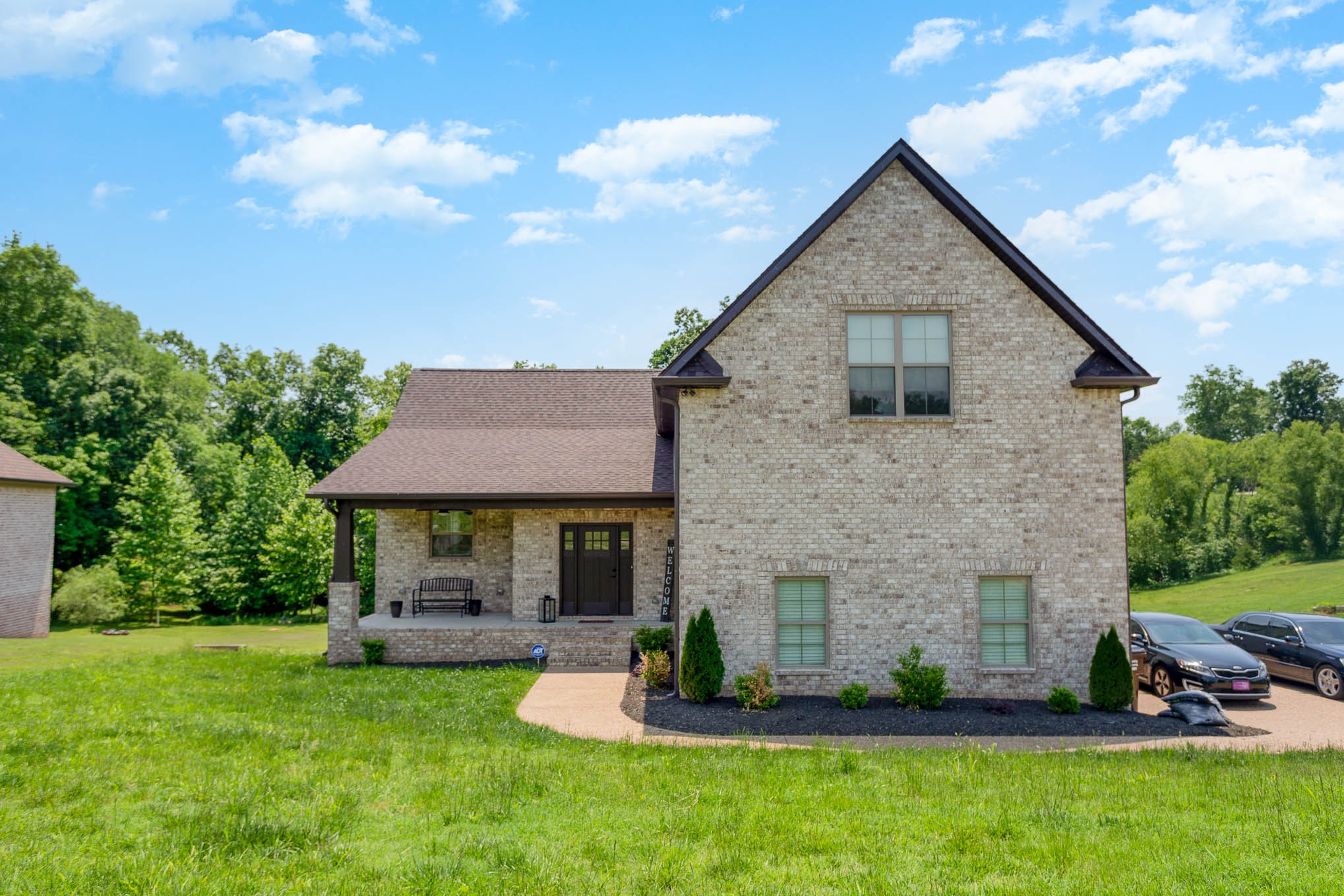 a front view of a house with a garden and plants