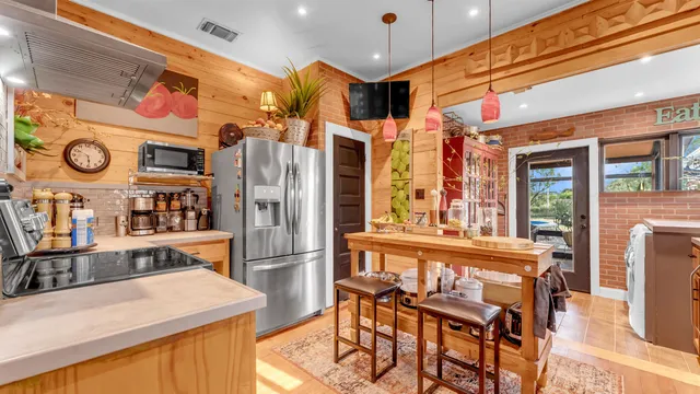 a kitchen with stainless steel appliances granite countertop a stove and a refrigerator