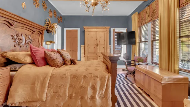 a large bed sitting in a bedroom next to a window