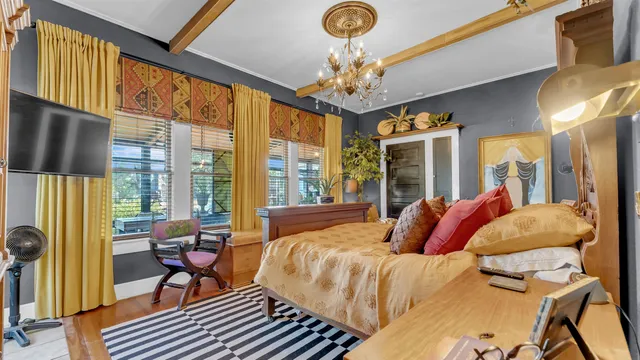 a bed sitting in a bedroom next to a window