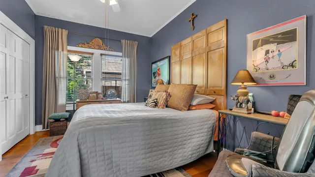 a bedroom with a bed and wooden floor