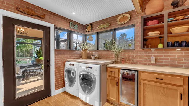 a view of a kitchen with a sink and a washer dryer