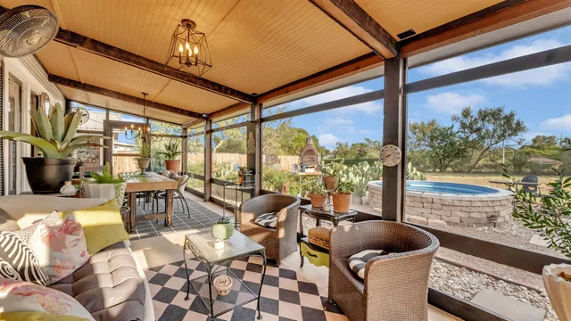 a living room with furniture and floor to ceiling windows