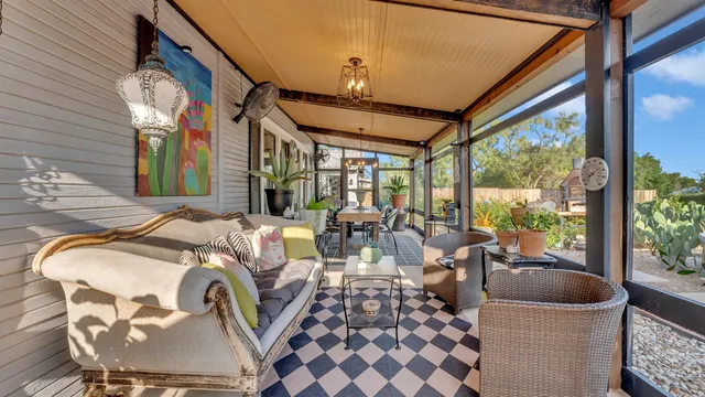 a living room with furniture and a floor to ceiling window