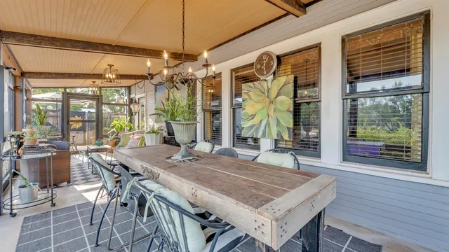 a view of a dining room with furniture large windows and wooden floor