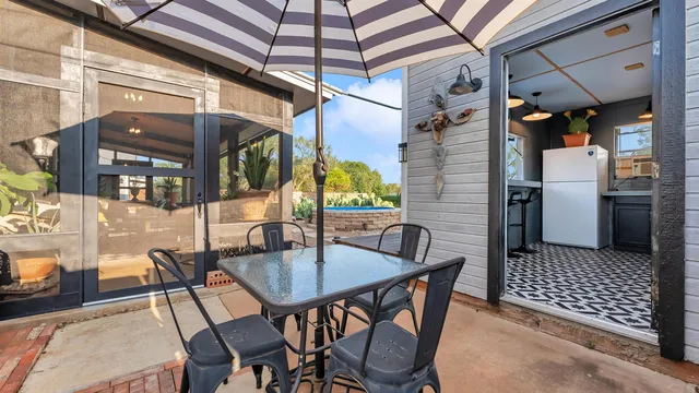a deck area with table and chairs