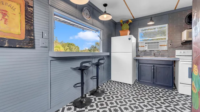 a kitchen with a refrigerator and a stove