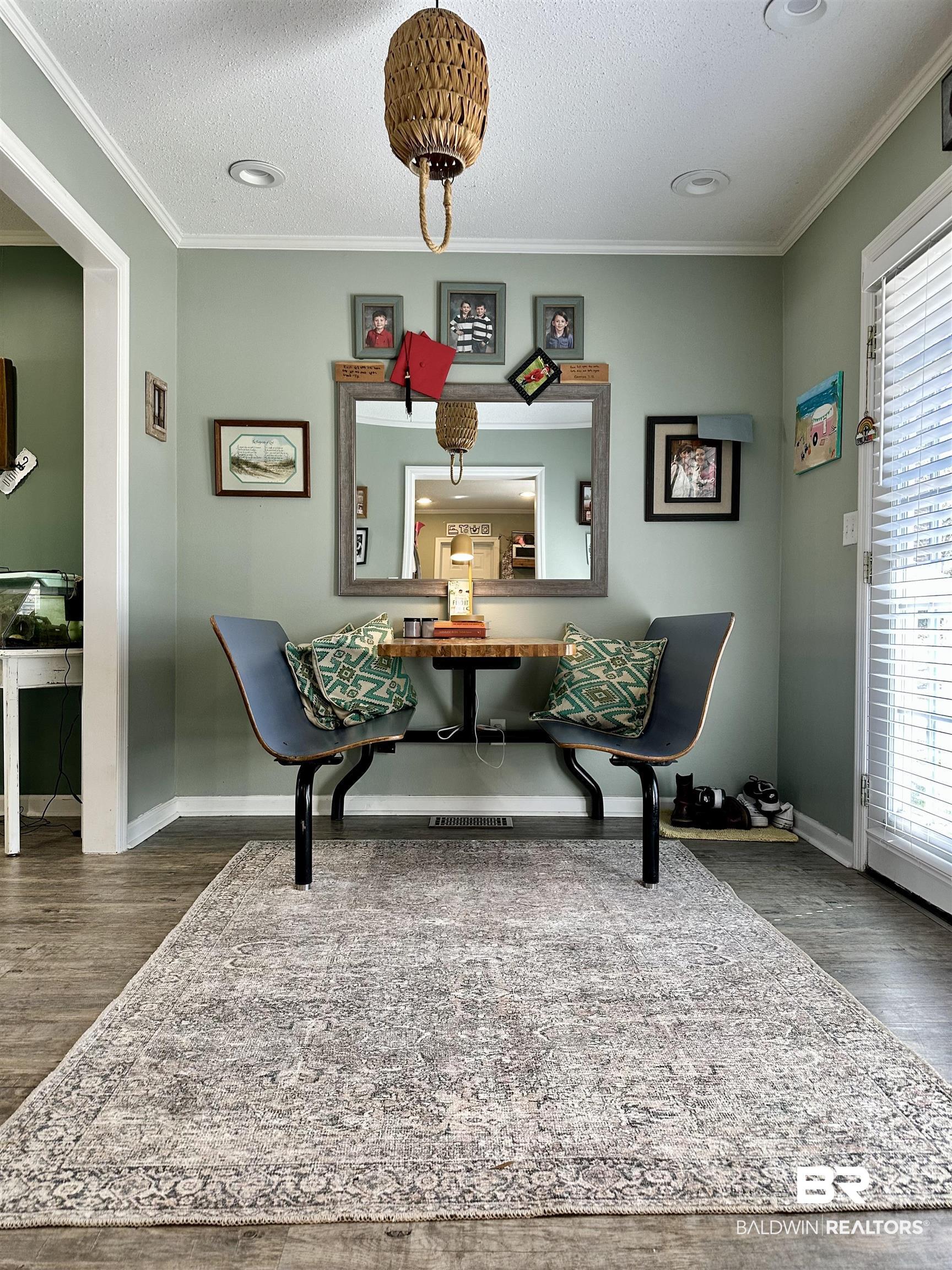 120 McGougin Road Brewton, AL 36426 - Photo 10 of 21 Living area featuring dark wood finished floors, crown molding, a textured ceiling, and baseboards
