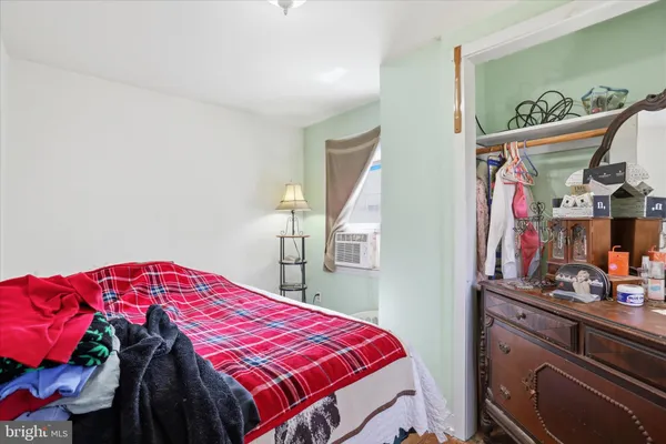 a bedroom with a bed and a closet