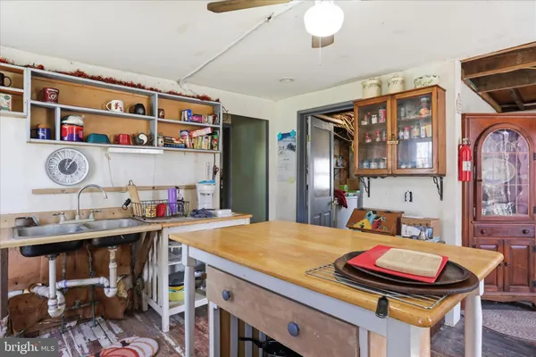 a living room with stainless steel appliances kitchen island granite countertop a dining table and chairs with wooden floor