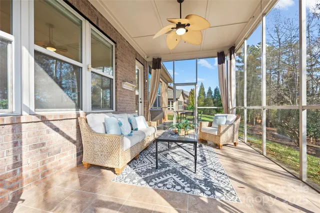 a living room with furniture and a floor to ceiling window