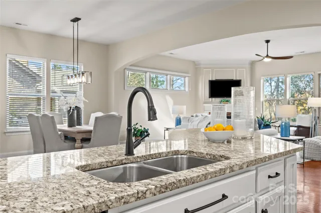 a kitchen with a sink a counter space and dining table