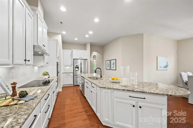 a spacious bathroom with sinks granite countertop a sink and a bathtub