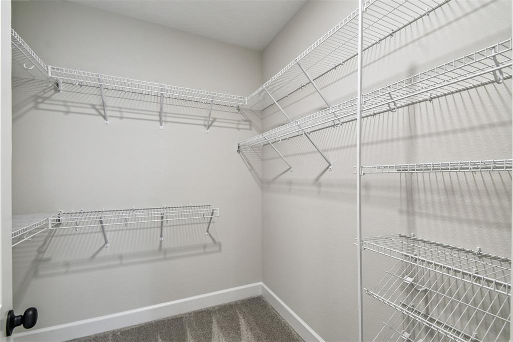 5262 Prairie Preserve Run St. Cloud, FL 34772 - Photo 11 of 40 a view of a room with racks on the wall