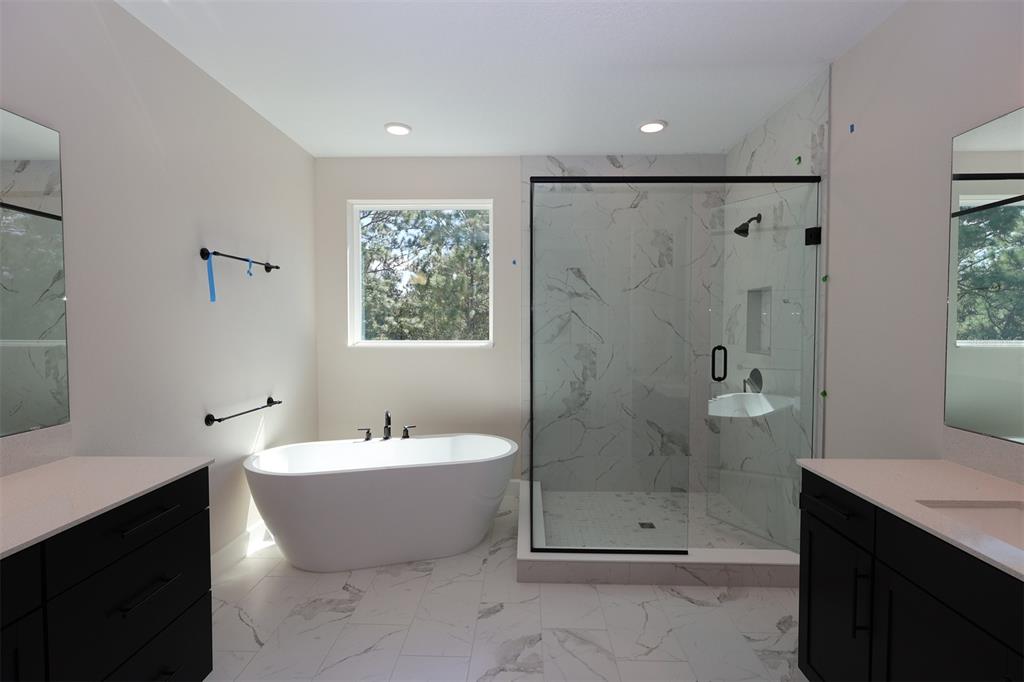 5262 Prairie Preserve Run St. Cloud, FL 34772 - Photo 12 of 40 a bathroom with a white bath tub a shower and a sink