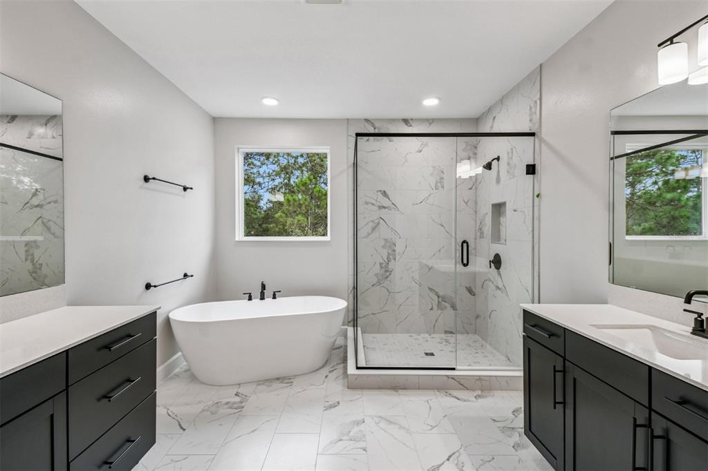 5262 Prairie Preserve Run St. Cloud, FL 34772 - Photo 14 of 40 a spacious bathroom with a bathtub sink mirror and toilet